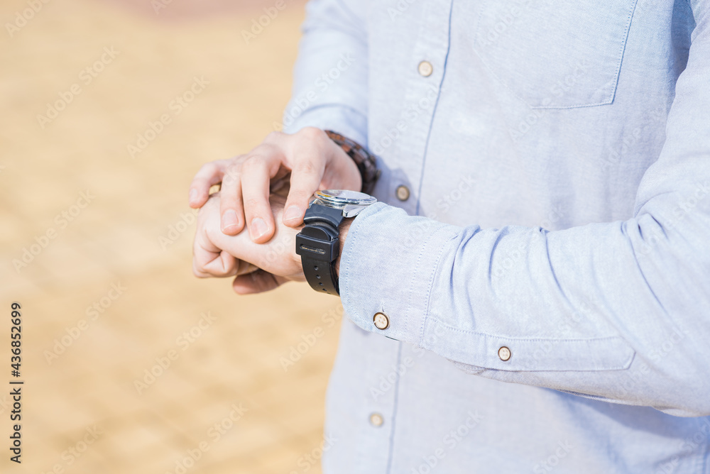 Close up of the hands of a male businessman on which the clock Close up of the hands of a male businessman on which the clock