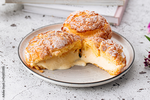 Fresh baked choux pastry cakes with cream filling photo