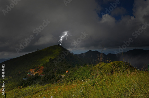 Strong lightning on mountaintop in the forest