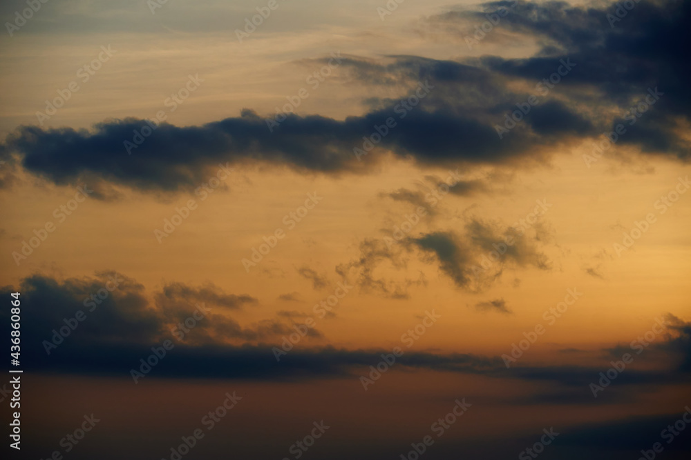 beautiful sunset sky, dark silhouette of clouds as a background