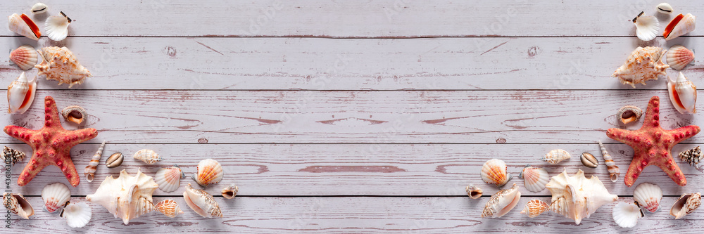 Banner with starfish and shells on a light wooden background with space for text Banner with starfish and shells on a light wooden background with space for text