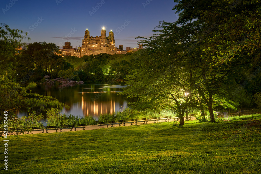 Central Park lake at night in Summer with view on Upper West Side buildings. New York City, Manhattan, NYC