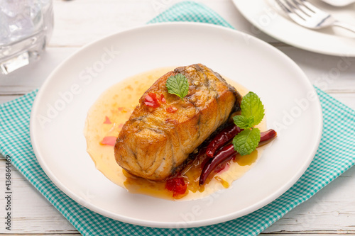 Fried sea bass with chili sauce or pla rad prik, a balanced hot, sour, salty and sweet sauce poured on the fried fish. It is one of popular Thai food dishes severed in restaurants throughout Thailand.