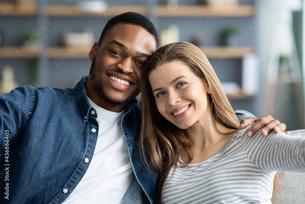 Portrait Of Cheerful Young Romantic Interracial Couple Taking Selfie Together At Home Portrait Of Cheerful Young Romantic Interracial Couple Taking Selfie Together At Home