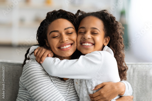Closeup portrait of bonding african american mother and daughter