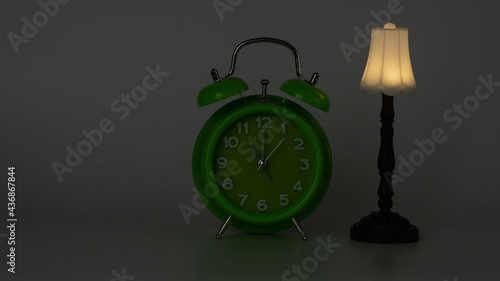Bed time. Green clock showing 11 PM and floor lamp captured under low light.