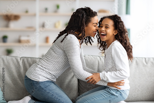 Photos Happy african american mom tickling her laughing kid