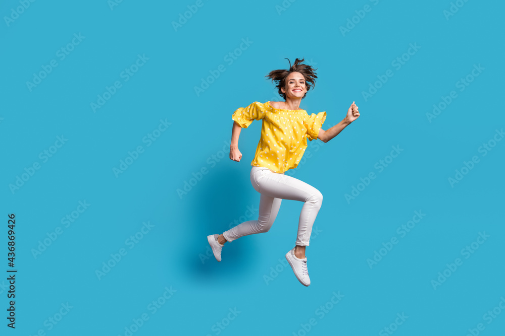 Full body profile side photo of happy woman jump run empty space smile sale isolated on pastel blue color background