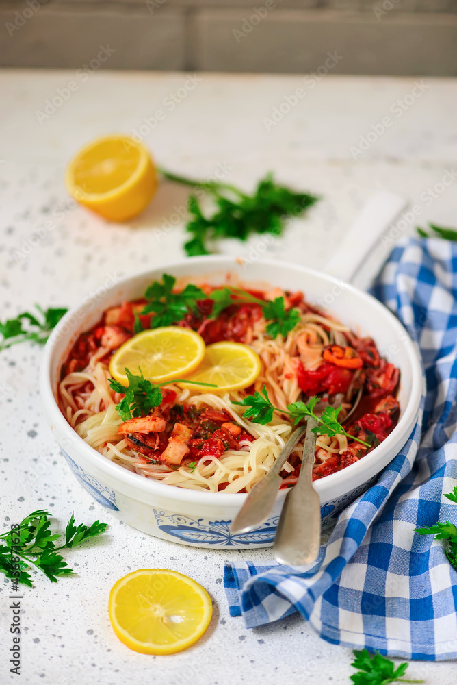 Italian seafood pasta in a white frying pan.top view Italian seafood pasta in a white frying pan.top view