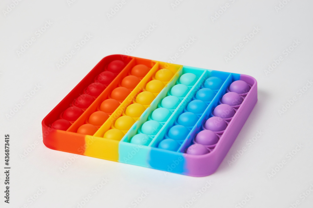 Multicolor poppit toy on a white background, close-up Multicolor poppit toy on a white background, close-up