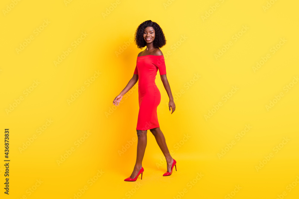 Full length profile portrait of satisfied dark skin person look camera bare shoulders isolated on yellow color background Full length profile portrait of satisfied dark skin person look camera bare shoulders isolated on yellow color background