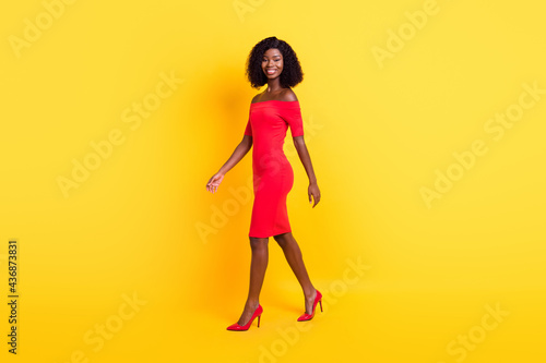 Full length profile portrait of satisfied dark skin person look camera bare shoulders isolated on yellow color background