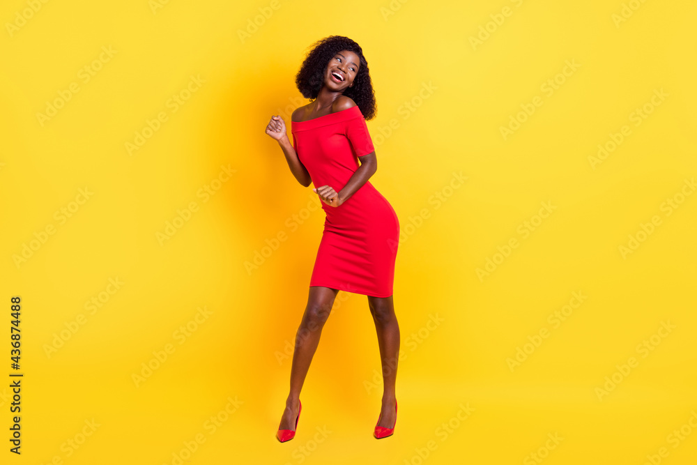 Full length photo of charming pretty dark skin woman wear red clothes dancing isolated yellow background Stock-foto | Adobe Stock