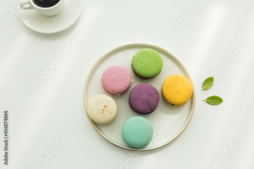 Sweet colorful macarons isolated on white background.