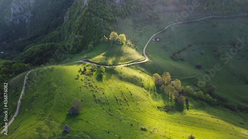 Mountain views with green hills, during spring. Aerial view of Dumesti village from Apuseni Mountains, Romania