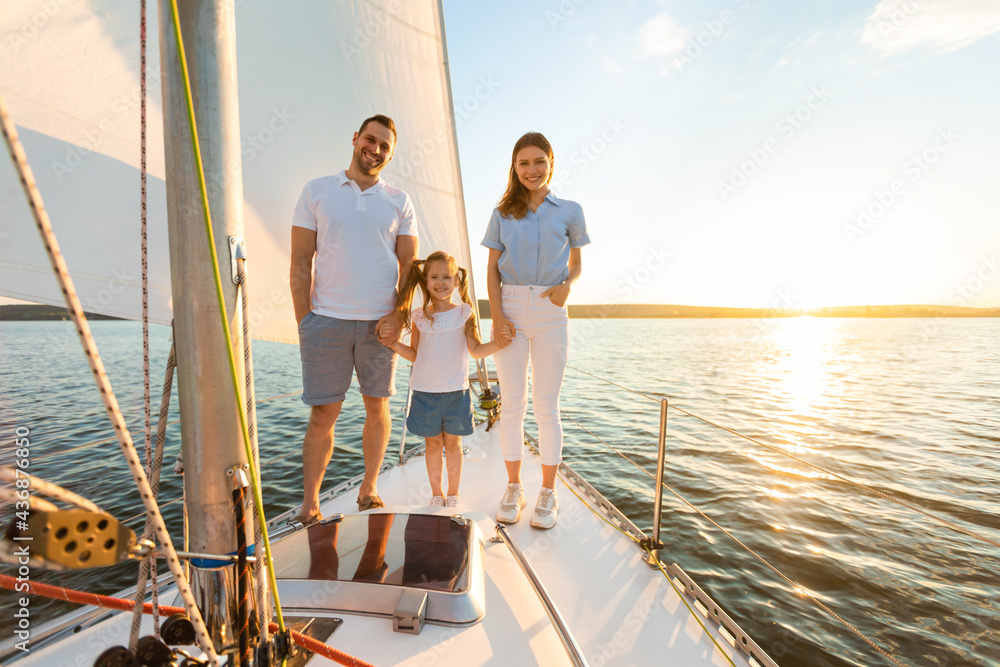 Family Standing On Boat Deck Sailing On Yacht In Sea Family Standing On Boat Deck Sailing On Yacht In Sea