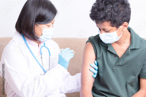 Medical care,woman doctor getting vaccine, doctor or nurse giving syringe shot to arm's patient. Vaccination, immunization, disease prevention against flu or virus pandemic business medical concept.
