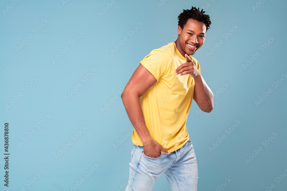 Photo of happy energized good-looking african american guy smiling and pointing at the camera. Photo of happy energized good-looking african american guy smiling and pointing at the camera.