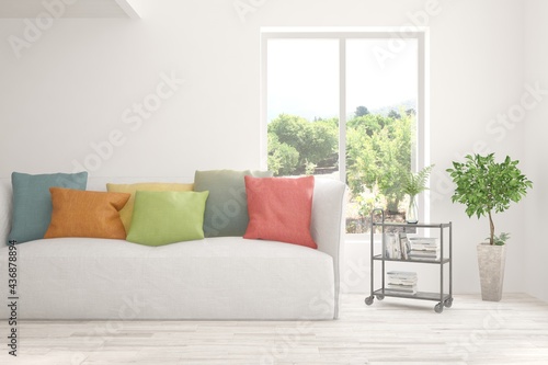 White living room with sofa and summer landscape in window. Scandinavian interior design. 3D illustration