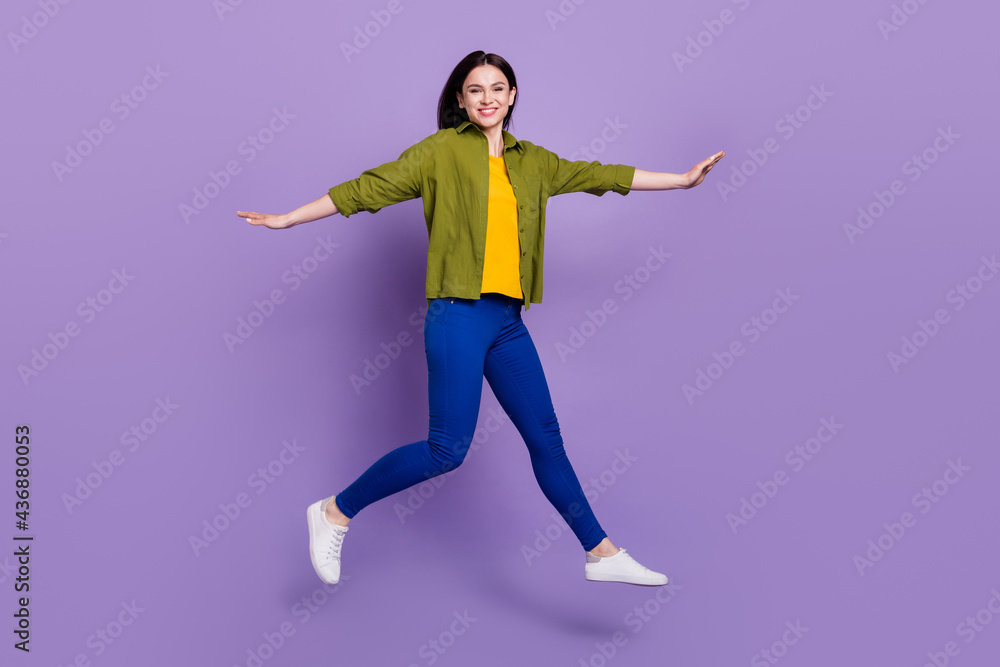 Full length profile side photo of young girl happy positive smile jump up go walk isolated over violet color background