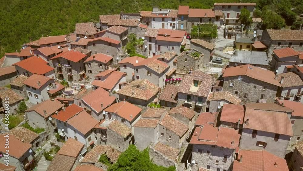 The small white houses with red roofs in Petrello Salto in Italy as seen on the aerial view The small white houses with red roofs in Petrello Salto in Italy as seen on the aerial view