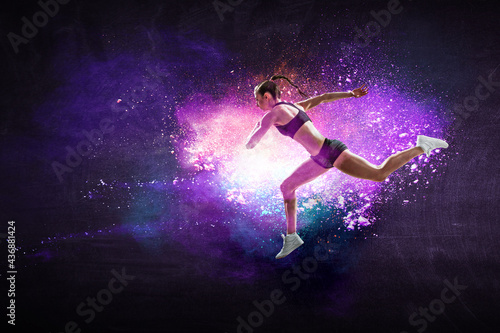 Athletic woman runner on colourful background © Sergey Nivens