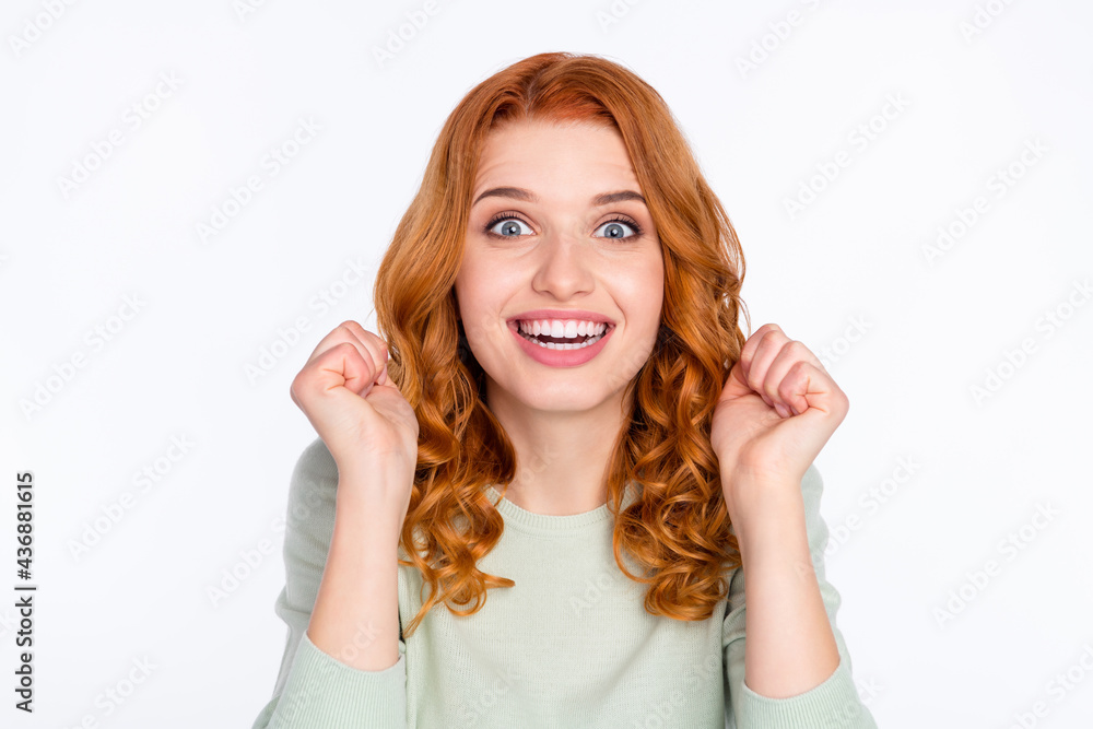 Photo portrait of red haired girl amazed smiling overjoyed gesturing like winner isolated white color background