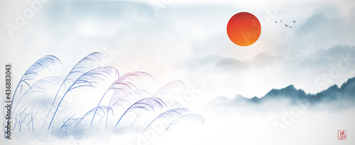 Leaves of grass on the wind, red sun and misty forest mountains. Traditional oriental ink painting sumi-e, u-sin, go-hua. Translation of hieroglyph - wind.