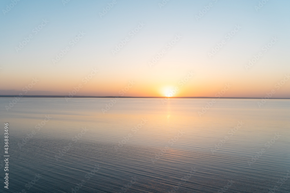 Horizontal line of calm sea at sunset