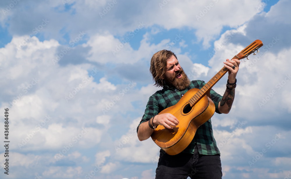 mature bearded man looking casual trendy playing guitar, acoustic music mature bearded man looking casual trendy playing guitar, acoustic music