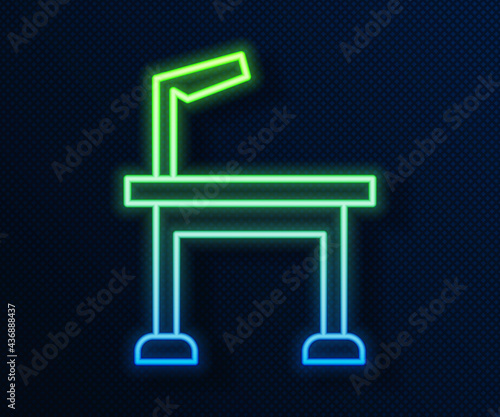 Glowing neon line Pet grooming table icon isolated on blue background. Vector