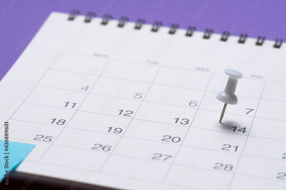 close up of pin on calendar on the purple table background, planning for business meeting or travel planning concept close up of pin on calendar on the purple table background, planning for business meeting or travel planning concept