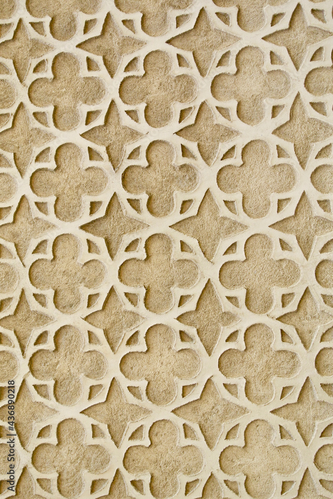 Classy detailed ornament on the wall. Beige stucco ornate outside