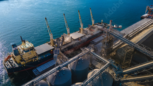 Industrial port in the field of import-export global business logistics and transportation, Loading and unloading container ships, cargo transportation from a bird's eye view.