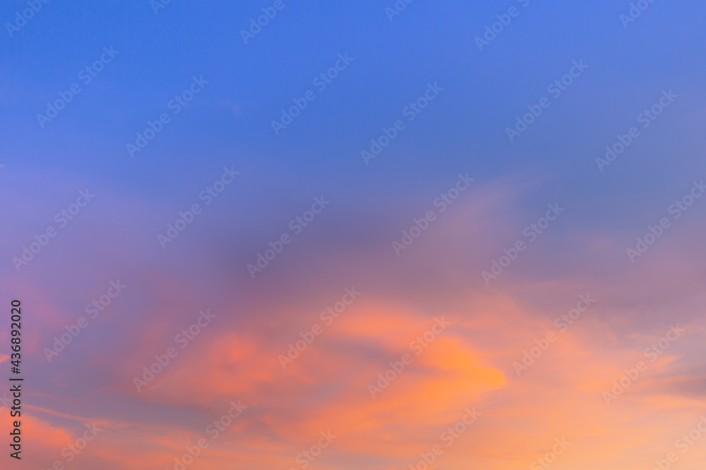 Clouds and sky in the evening,Sky blue and orange light of the sun through the clouds in the sky