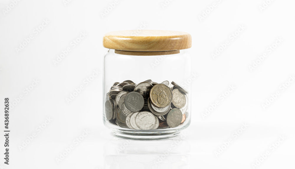 coin in glass bottle on white background,Coin in glass jar, Saving money concept on white background. coin in glass bottle on white background,Coin in glass jar, Saving money concept on white background.
