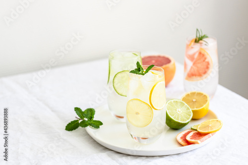 Summer cold beverage with citrus fruits and sliced citrus fruits.