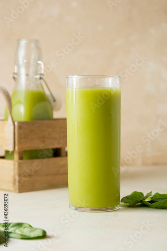 Smoothie with banana, spinach and lime. Healthy detox green drink glass.
