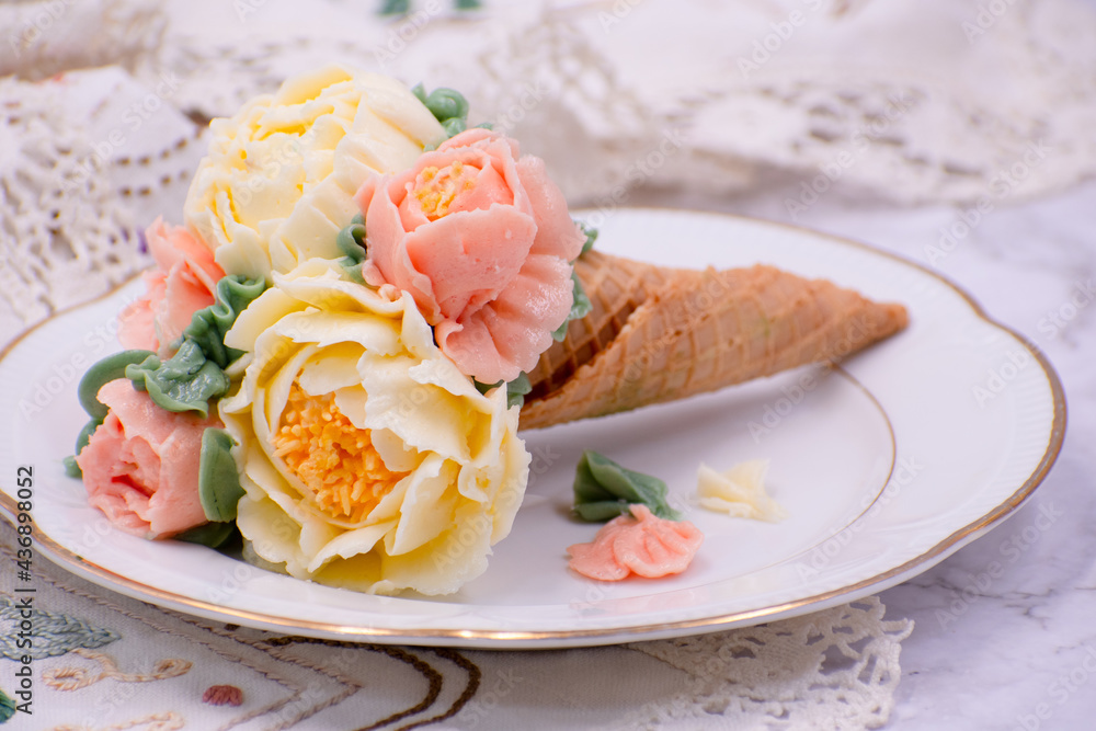 Beautiful piped buttercream flowers in cone cupcakes on stylish table