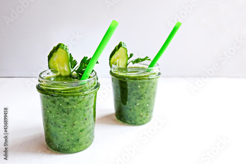 Green cocktail of spinach, lemon, cucumber and parsley on a light background. The concept of healthy nutrition, detox, green, diet, vegan, keto, fit
