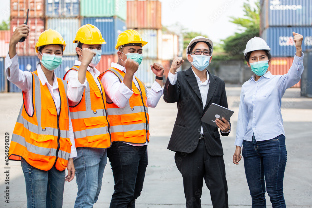 Portrait of Asian logistic worker group happy for successful work. people wearing protective mask working during Coronavirus at warehouse construction site. export import business Portrait of Asian logistic worker group happy for successful work. people wearing protective mask working during Coronavirus at warehouse construction site. export import business