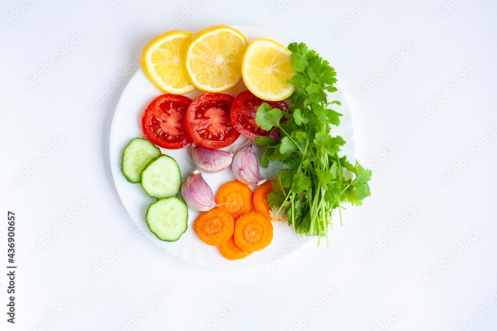 Summer menu, a plate of fresh vegetables on a white background, flat lay Summer menu, a plate of fresh vegetables on a white background, flat lay