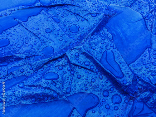 Droplets of rainwater on the blue tarp