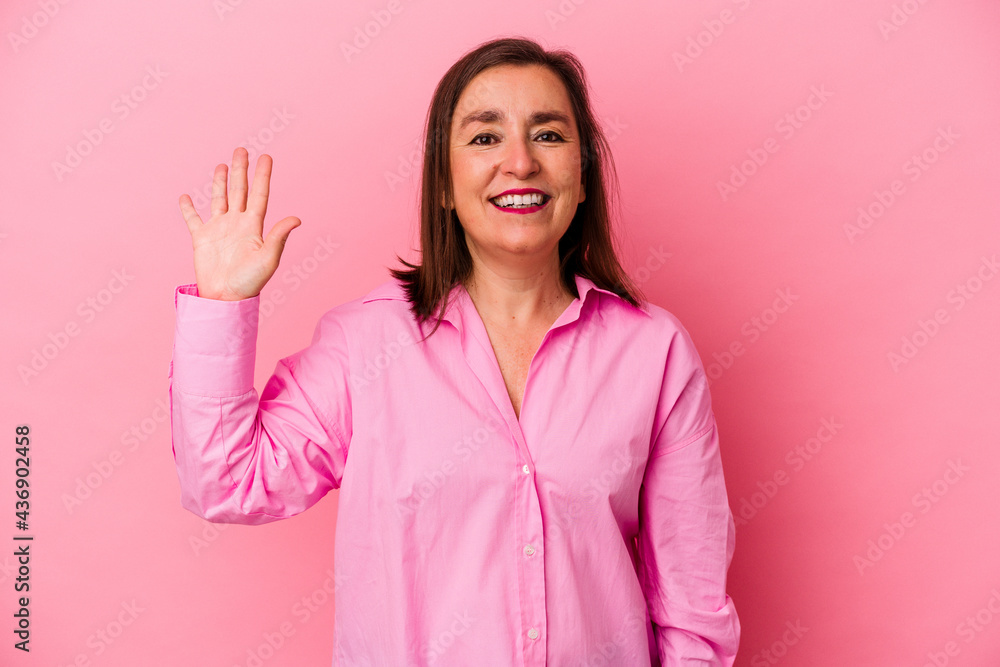 Middle age caucasian woman isolated on pink background smiling cheerful showing number five with fingers. Middle age caucasian woman isolated on pink background smiling cheerful showing number five with fingers.