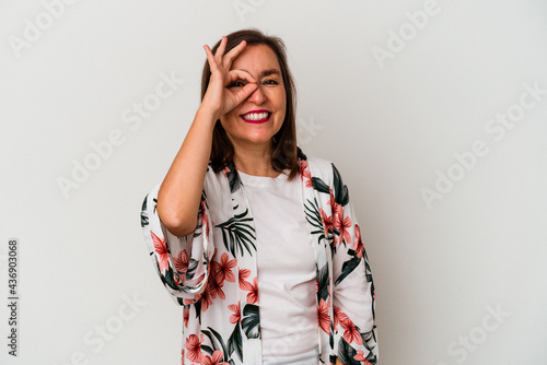 Middle age caucasian woman isolated on white background excited keeping ok gesture on eye.