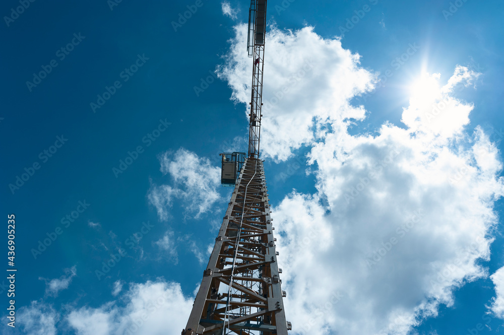 Crane, backhoe, clouds, sky.