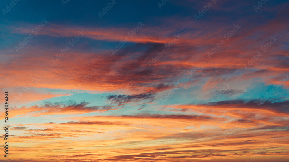 isolated shot of vibrant colored sky with clouds at sunset