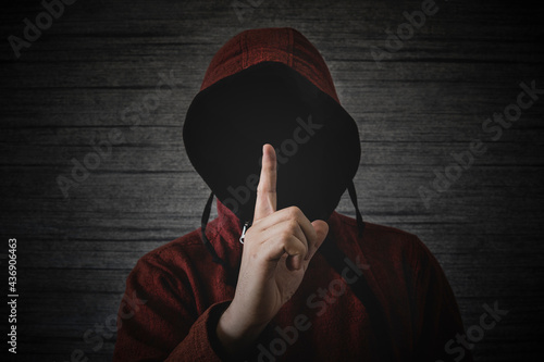 Quadro em tela unknown person without a face in a hood shows a finger gesture meaning towns