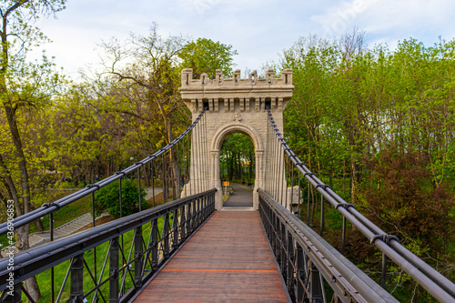 Konstfotografi Photography of a suspended bridge over the river in the park in Craiova, Romania