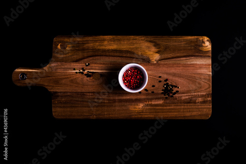 Red peppercorns in a bowl. Top view photo